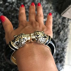 Black and gold bracelet with kissing cheetahs.